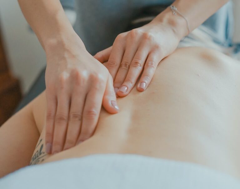 man massaging woman's body